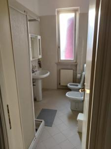 a bathroom with two toilets and a sink and a window at Il Portichetto in Rivergaro +16 photos