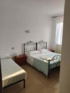a bedroom with two beds and a window at Il Portichetto in Rivergaro