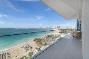 a balcony with a view of the beach and the ocean at 3Bed Private Beach - Belle vie à La Vie Dubai in Dubai
