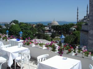 a restaurant with tables and flowers on a balcony at No20 Hotel Sultanahmet in Istanbul