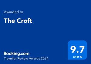 a blue sign with the text awarded to the croft travelling review awards at The Croft in Hilton