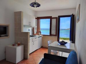 a kitchen with a view of the ocean at Case per Vacanze Praia in Favignana