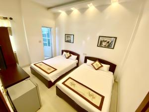 um quarto com duas camas e um espelho em Hoian Old Town Hostel em Hoi An