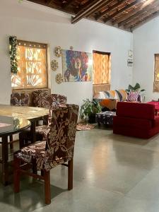 a living room with a table and chairs and a couch at The Wild Flower! in Anjuna