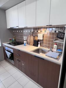 a kitchen with a sink and a stove at Charming Peaceful 3BR in heart of Rhodes in Sydney