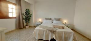 a bedroom with a large bed with two night stands at Ten minutes from airport in Vecindario