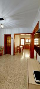 a living room with a table and a dining room at Ten minutes from airport in Vecindario