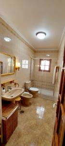 a bathroom with two sinks and a toilet and a shower at Ten minutes from airport in Vecindario