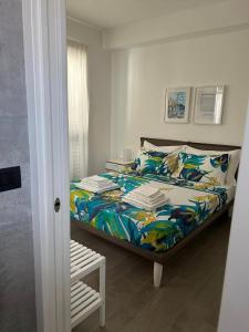 - une chambre avec un lit et une couette colorée dans l'établissement Farau B&B, à Messina