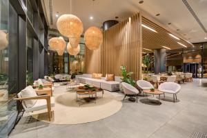 a lobby with couches and tables and chairs at DoubleTree by Hilton Porto Alegre in Porto Alegre