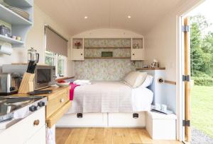 a small bedroom with a bed in a tiny house at Apple in Sherborne
