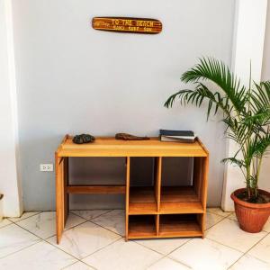 a wooden desk in a room with a plant at Tides Lobitos in Lobitos