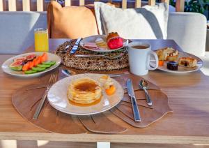a table with plates of breakfast foods and a cup of coffee at DoubleTree by Hilton Porto Alegre in Porto Alegre