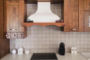 a kitchen with a counter top with a shelf on the wall at Casa di campagna in Faskomiliá +67 photos