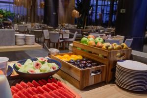 a buffet of fruits and vegetables on a table in a restaurant at DoubleTree by Hilton Porto Alegre in Porto Alegre