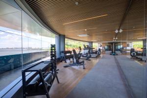 a gym with treadmills and a large glass wall at DoubleTree by Hilton Porto Alegre in Porto Alegre