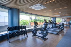 a gym with treadmills and elliptical machines at DoubleTree by Hilton Porto Alegre in Porto Alegre