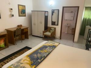 a room with a bathroom with a toilet and a sink at Casablanca Guest Inn in Sekondi-Takoradi