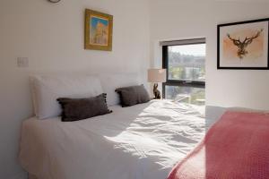 een wit bed met 2 kussens in een slaapkamer bij Discovery Barn - Luxury 2 Bed Barn Conversion! in Cropthorne