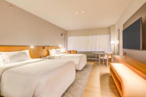 a hotel room with two beds and a table at DoubleTree by Hilton Porto Alegre in Porto Alegre