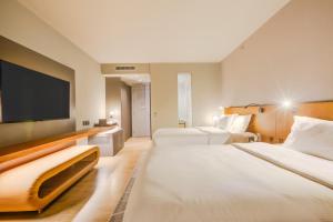 a hotel room with two beds and a flat screen tv at DoubleTree by Hilton Porto Alegre in Porto Alegre