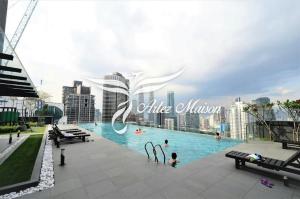a large swimming pool with people in a city at Dorsett Residences Service Suites Bukit Bintang Kl in Kuala Lumpur