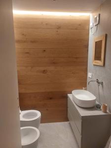 a bathroom with two toilets and a sink at Sauze Apartment in Sauze dʼOulx