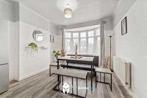 a dining room with a table and a window at 3 Bedroom House By Invicta Stays Short Lets Near City Centre Leicester With Free Wi-Fi Free Parking in Leicester