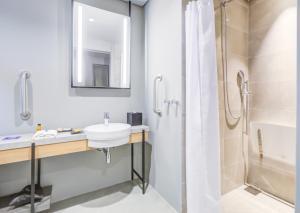 a bathroom with a sink and a shower at DoubleTree by Hilton Porto Alegre in Porto Alegre