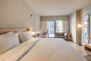 a large white bed in a room with a window at DoubleTree by Hilton Porto Alegre in Porto Alegre