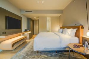 a hotel room with a bed and a tv at DoubleTree by Hilton Porto Alegre in Porto Alegre