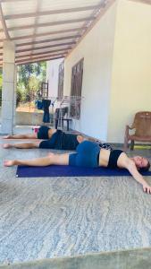 a group of women laying on the floor doing yoga at Elisha Place Hiriketiya in Dickwella