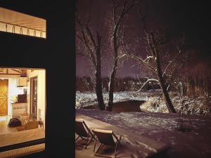 two pictures of a house with snow and a window at Heaven Reset & Spa - Domek przy lesie in Korczew