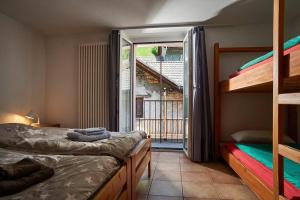 een slaapkamer met 2 stapelbedden en een balkon bij Wild Valley Forest View 3 in Valle Onsernone in Vergeletto