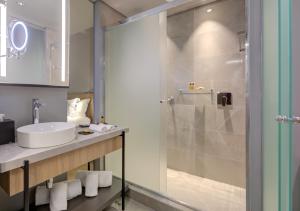 a bathroom with a sink and a shower at DoubleTree by Hilton Porto Alegre in Porto Alegre