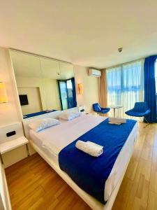 a bedroom with a large bed with a large mirror at ORBI CITY batumi in Batumi