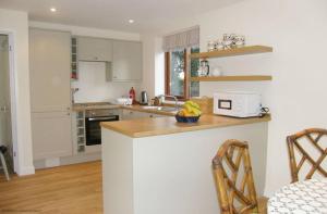 a kitchen with white cabinets and a counter with a microwave at Maplescombe in Alton