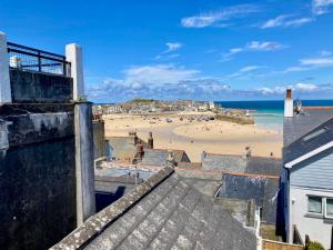 a view of a beach from the roof of a building at Barn conversion in Zennor in St Ives