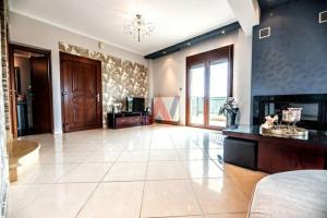 a large living room with a fireplace and a room at Το πέτρινο σπίτι in Nea Plagia