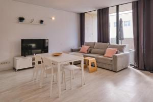 a living room with a table and a couch at Aeropuerto loft 8 by Azahar Stay in Manises