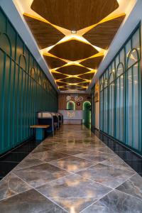 a hallway of a building with green walls and a ceiling at Mihman Hotel in Tuzla