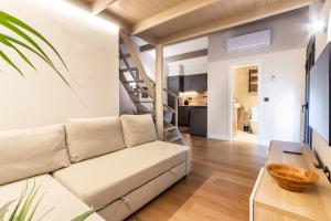 a living room with a couch and a staircase at Exclusive Apartments Barcelona 4 personas Vall in Terrassa