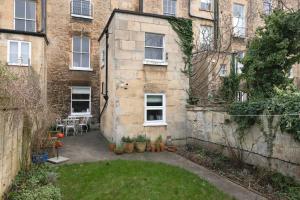 an outside view of a building with plants in a yard at The Courtyard Georgian Apartment - 2 Bedrooms in Bath
