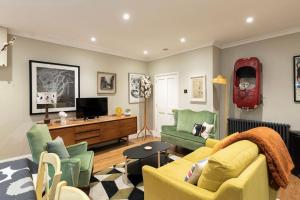 a living room with a couch and two chairs at The Courtyard Georgian Apartment - 2 Bedrooms in Bath