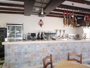 a kitchen with a counter top and a unintention at Hostal Restaurante La Ilusion in El Palmar