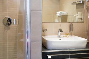 a bathroom with a sink and a shower at Hotel La Baia in Cochem