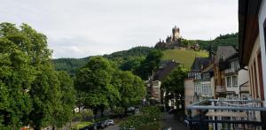 a town with a castle on top of a hill at Hotel La Baia in Cochem