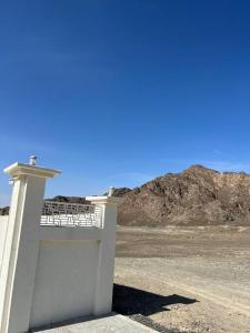 a white building in the middle of a desert at Masfout/hatta mountain villa in Sinādil