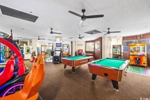 a room with two pool tables and arcade games at Oceanfront Paradise/Waterpark/pools/lazyriver in Myrtle Beach