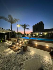 a backyard with a swimming pool at night at IL CASALE POMPEIANO in Pompei